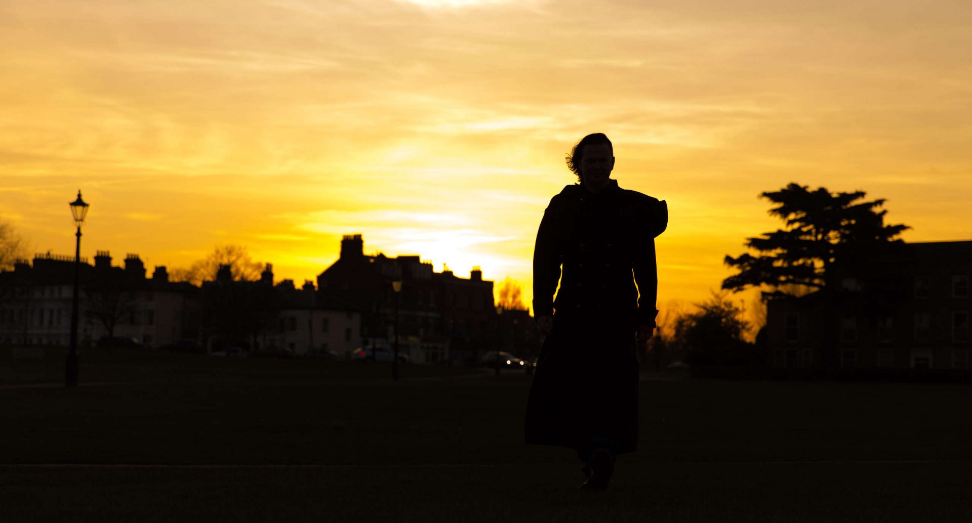 Blog header image, me silhouetted against an orange/yellow sunset